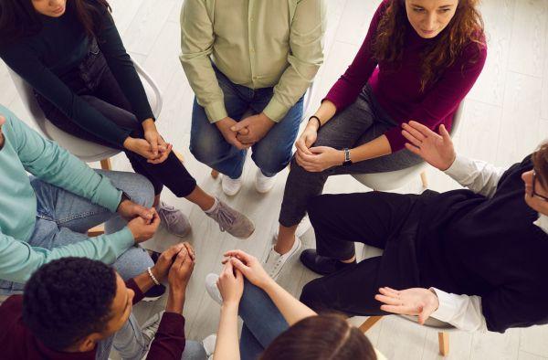 A group of people listening in a circle.