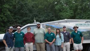 group of seven men and one woman standing side by side