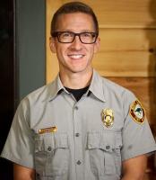 man with glasses in park ranger outfit