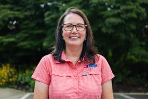 woman with brown hair and glasses in a red button up shirt