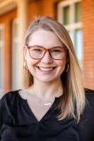woman with blonde hair and glasses