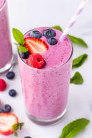 purple smoothie with strawberries, blueberries, and raspberries