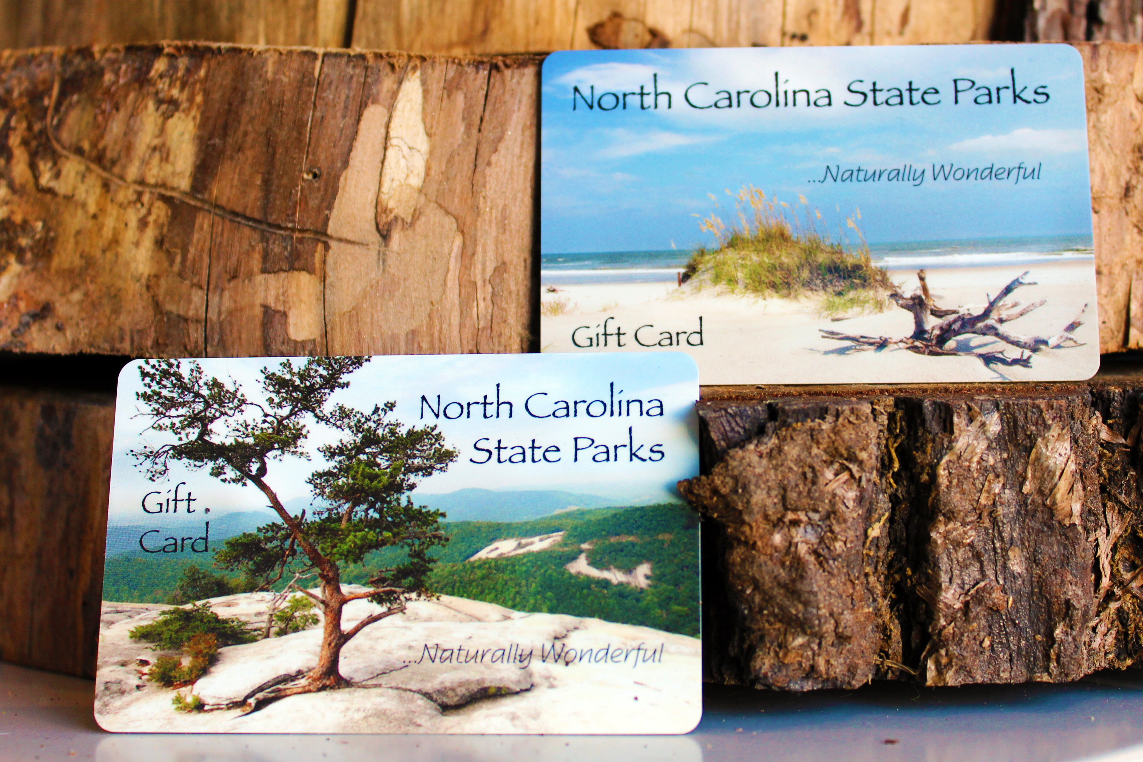 North Carolina State Parks gift cards staged against logs