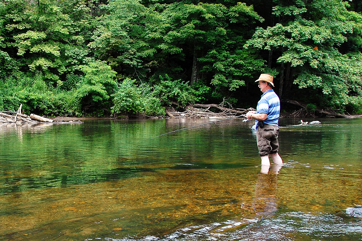 Visitor fishing on the river at New River State Park