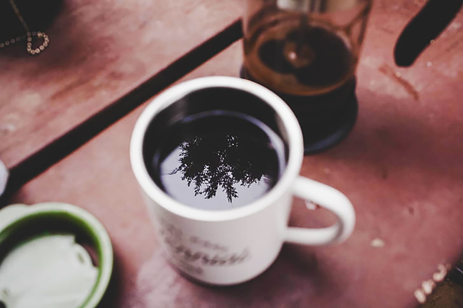 Coffee mug on a picnic table: stock photo