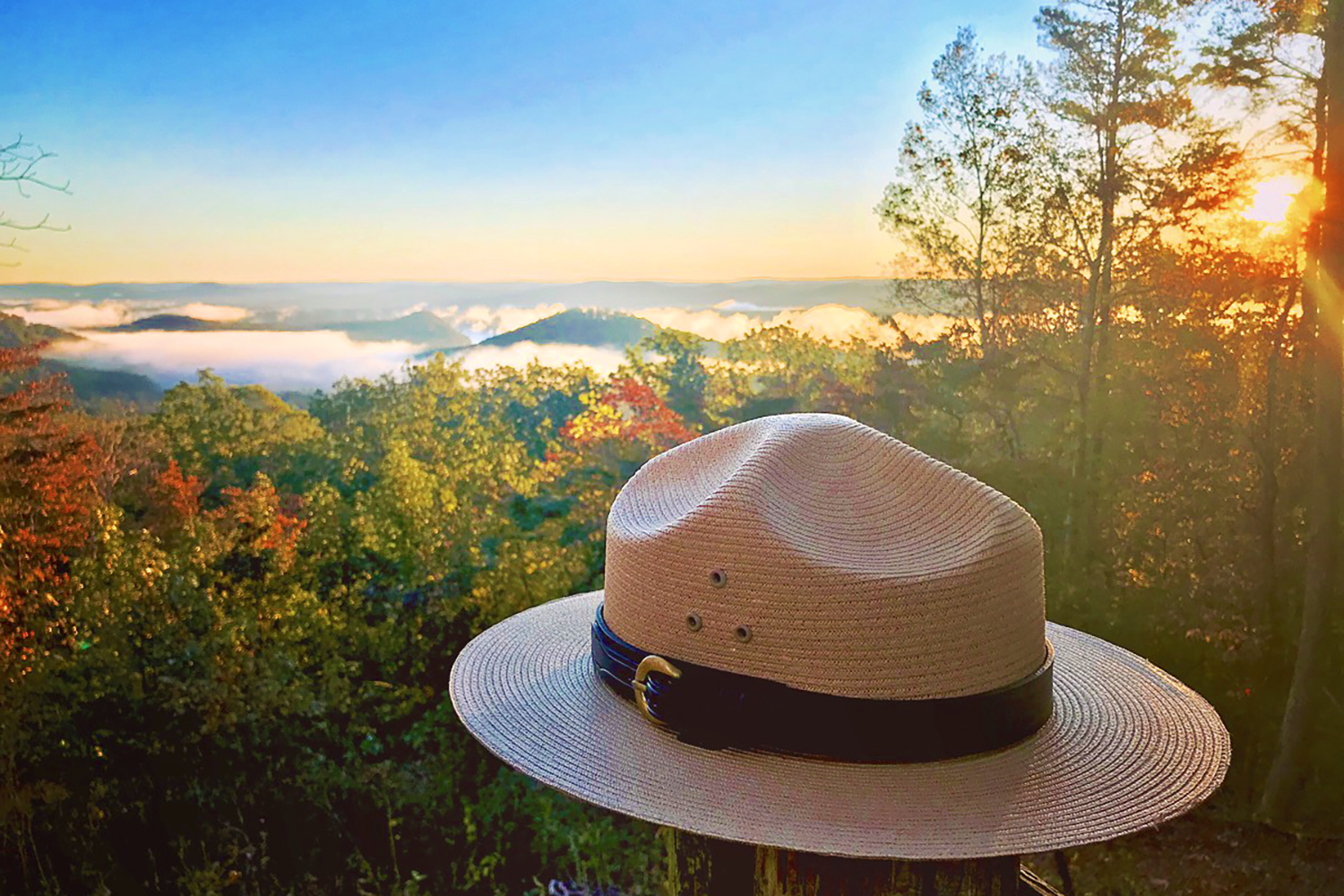 Ranger hat with a scenic fall view of the Uwharries in the background at Morrow Mountain State Park
