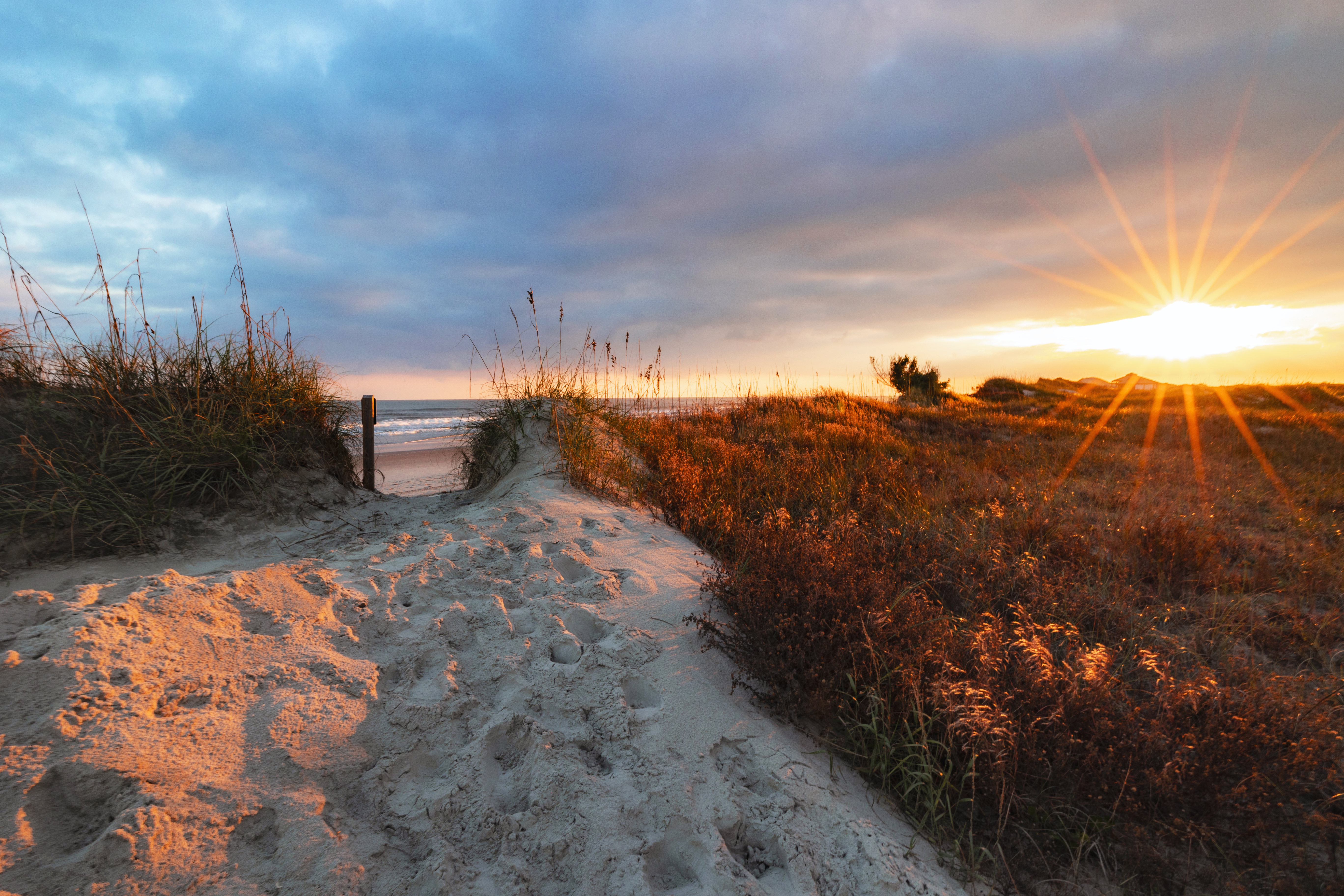 A Hammocks Beach campsite nestled behind the dunes on Bear Island at sunset