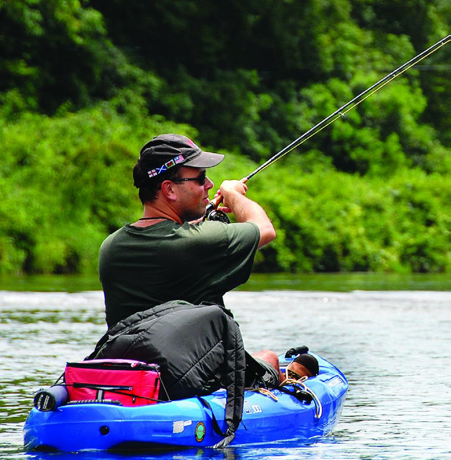 Photo of a person fishing from a blue kayak at New River State Park