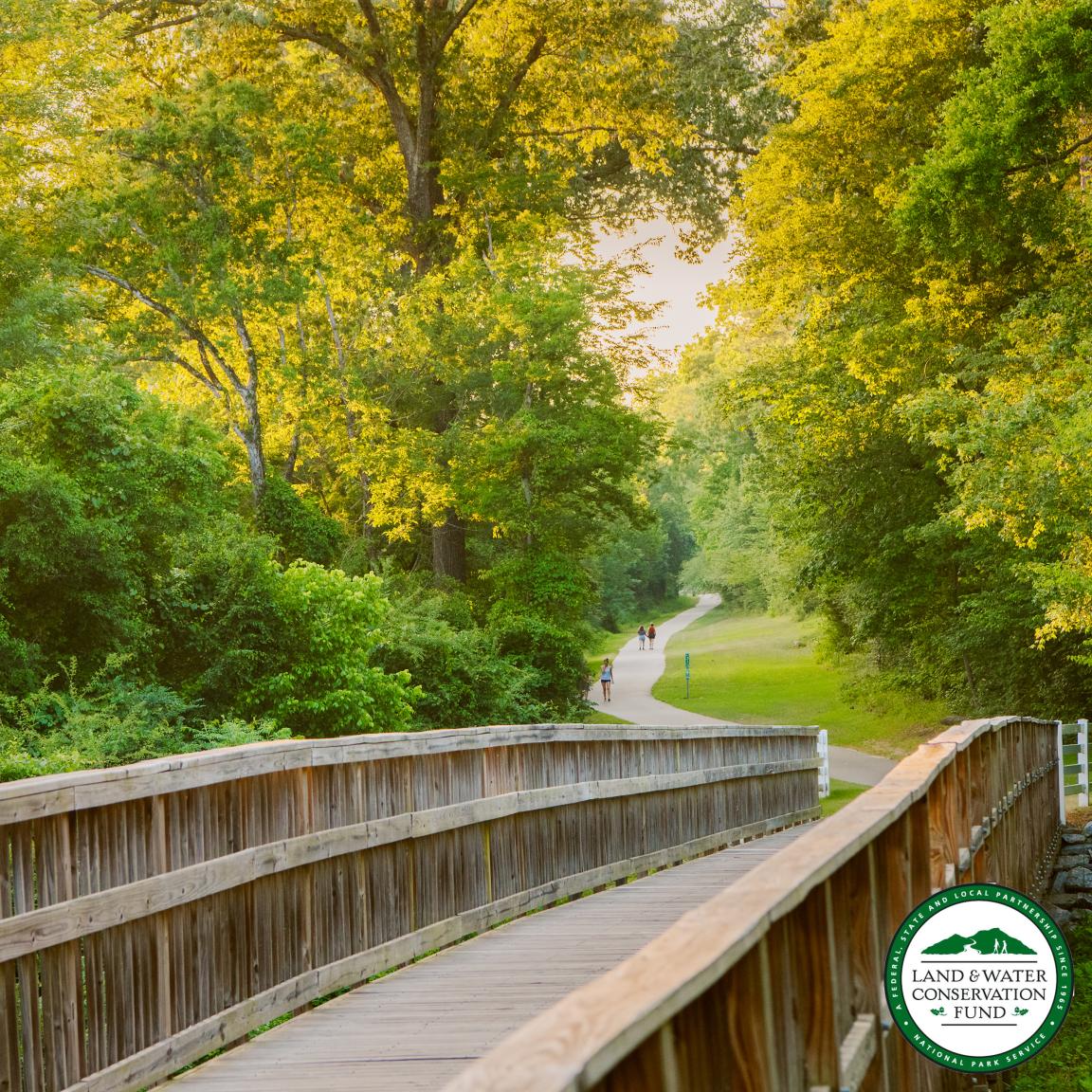 A greenway on the Mountains-to-Sea State Trail, which is the cover image for the LWCF application, with the LWCF logo