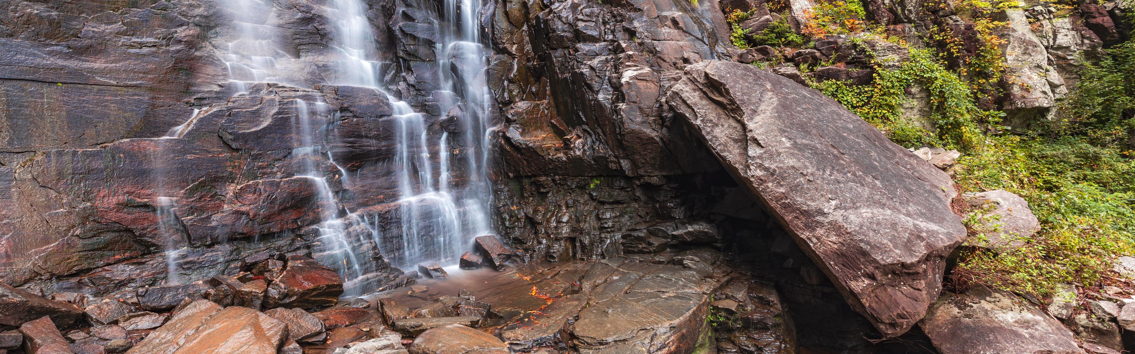 The bottom section of Hickory Nut Falls flows on a fall day