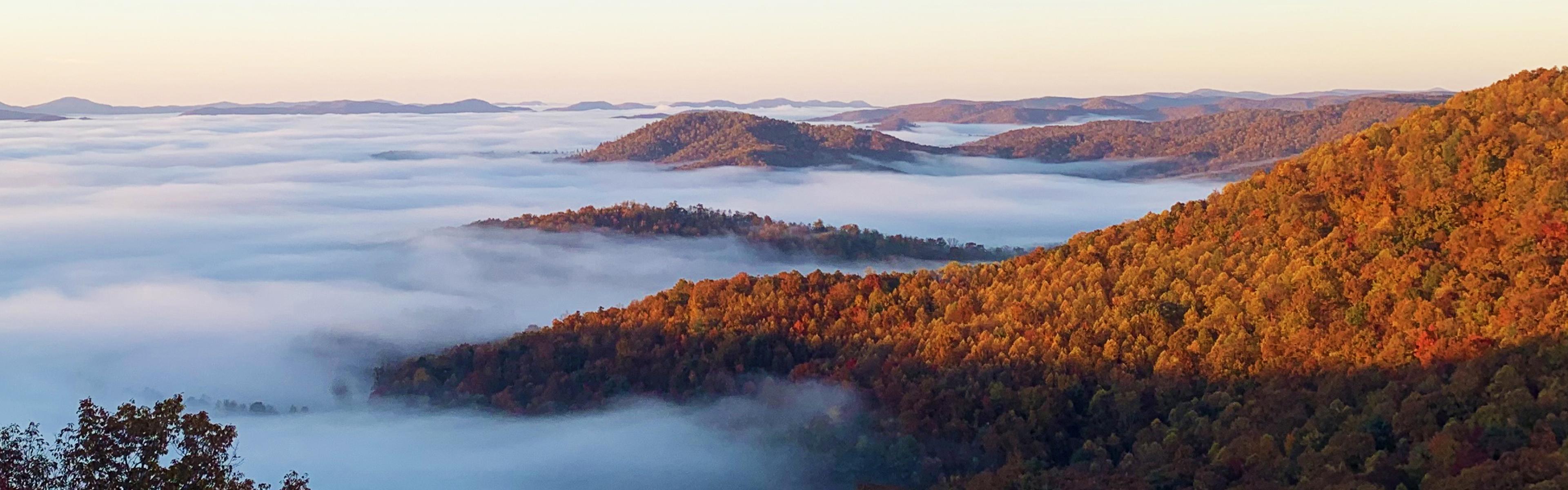 A fall sunrise and cloud inversion with mountains poking through