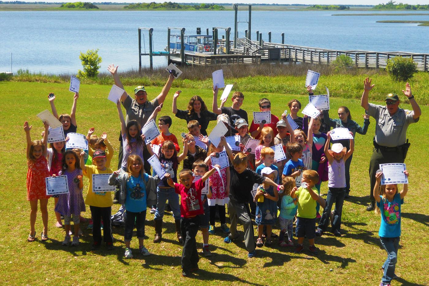 Junior Rangers show off their certificates at Hammocks Beach State Park