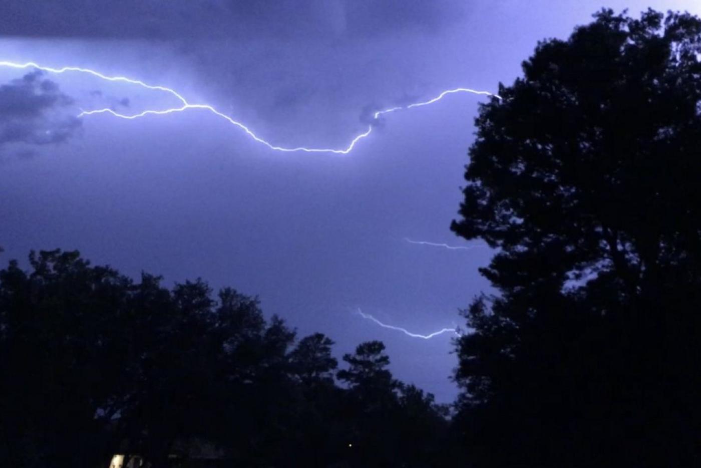 lightning in clouds with trees