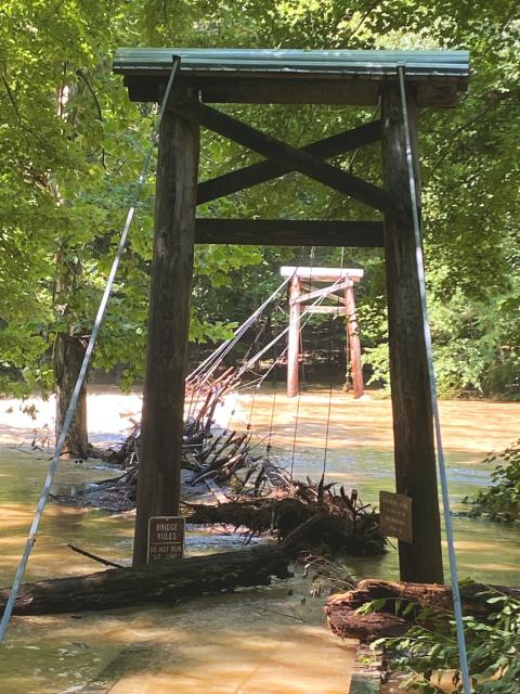 Flooding of Cox Mountain swinging bridge at Eno River State Park in July 2025 due to Tropical Storm Chantal.