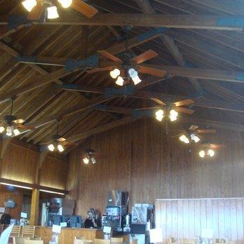 Interior view of the restaurant dining room showing heavy wooden ceiling beams and light fixtures