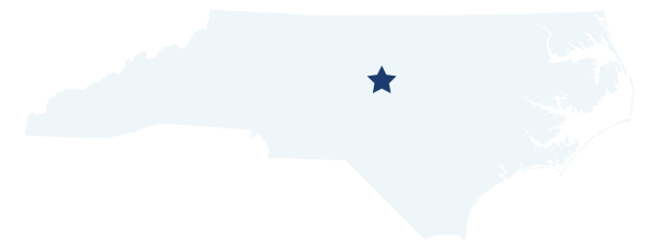 light blue map of north carolina with a star designating the location of the lower haw river state natural area, towards the center of the state.