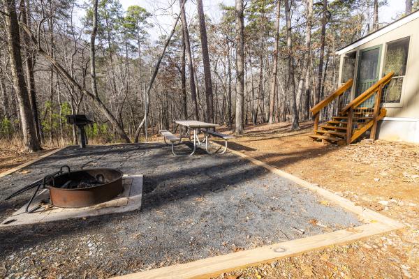 a clean campsite outside of a camper cabin in the wintertime