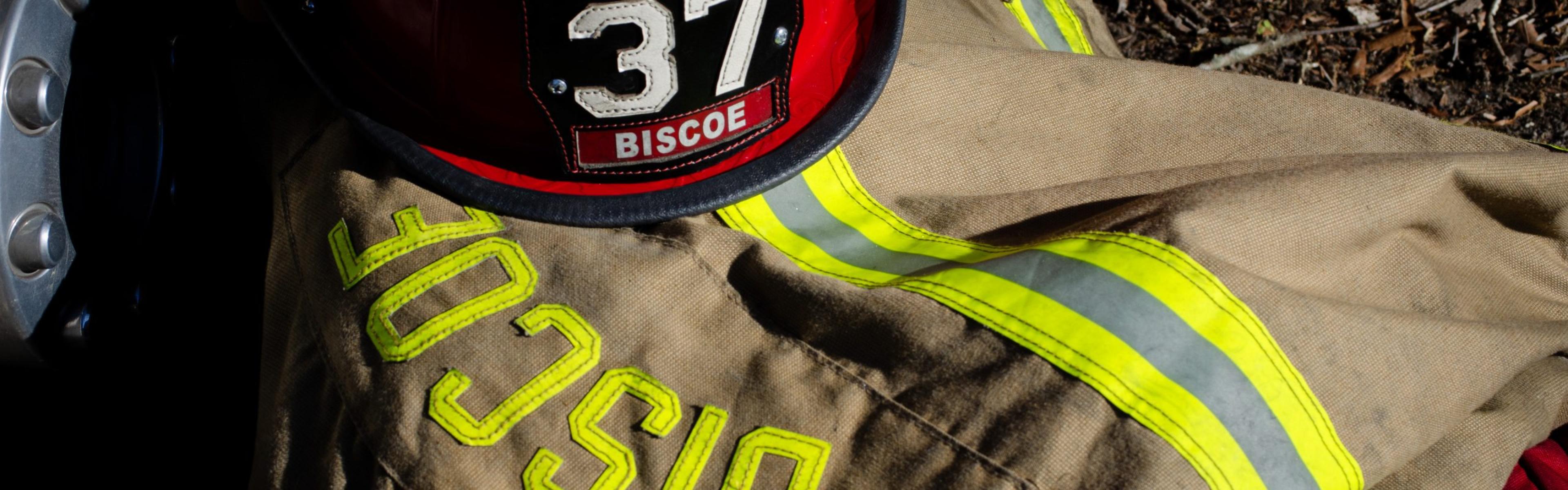 Firefighter turnout gear with reflective stripes and a red helmet labeled “Lieutenant 37 Biscoe.”