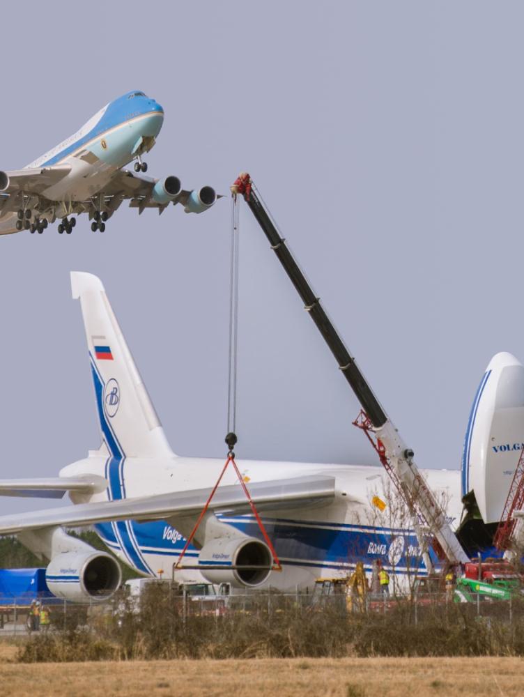 Air Force One plane landing above plane under maintenance
