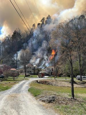 Wildfire burning near homes.