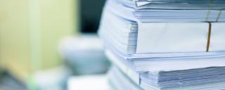 Large stack of binders with documents