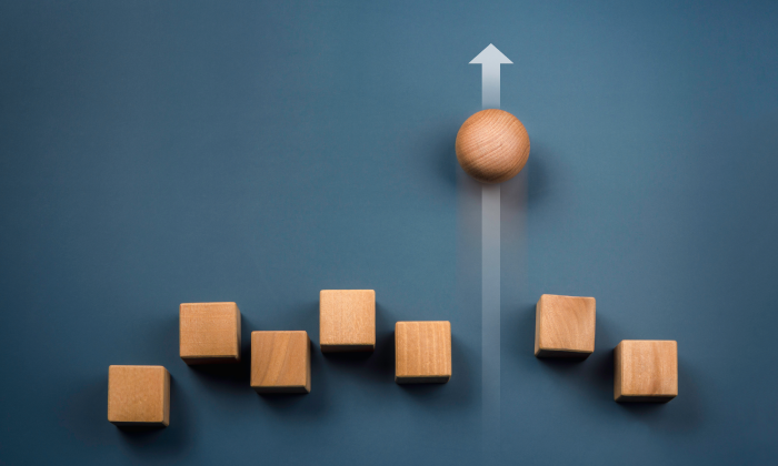 Dark blue background with 7 wooden block and 1 sphere. The shapes are at different levels. 