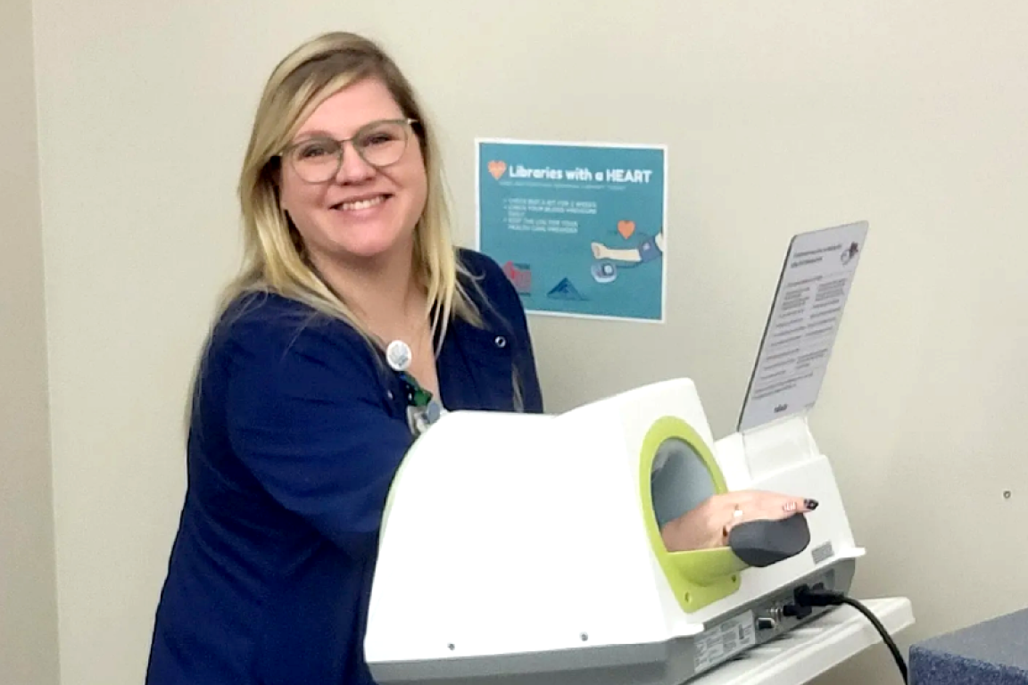 NC library patron using Fontana Regional Library's blood pressure machine