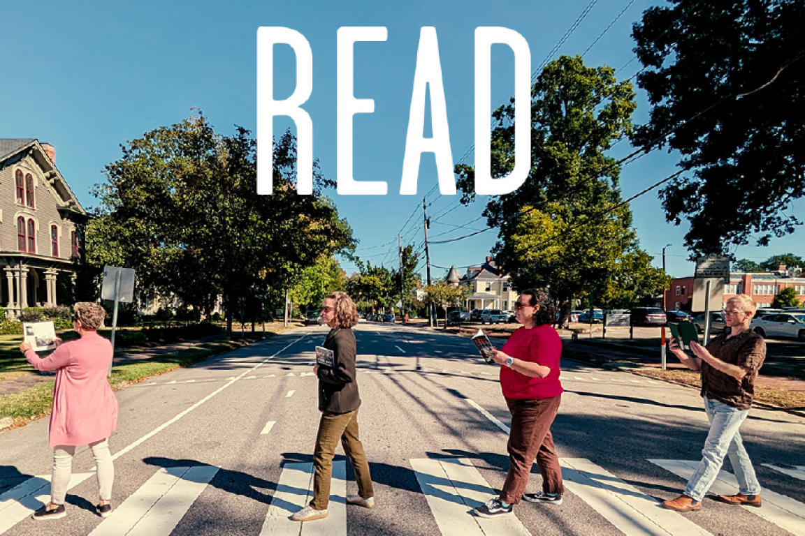 Four individuals walk across a crosswalk while holding books. Large text says “READ.” A small graphic reads “Libraries Are For Everyone.”