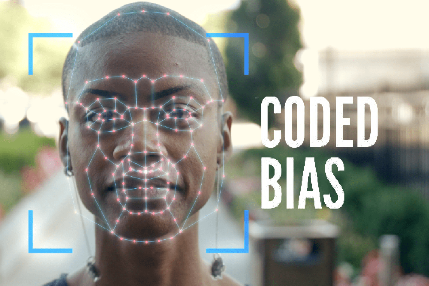 closeup image of a woman's face with an illustration of face recognition software over her face.