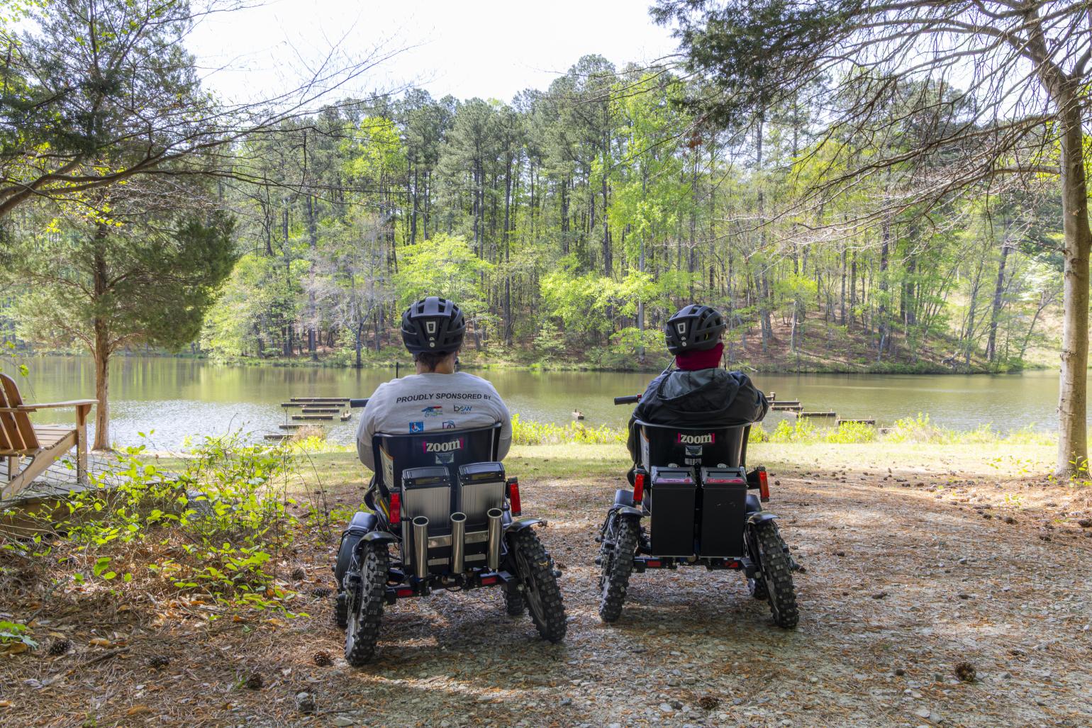 Two park visitors at William B. Umstead State Park take in the views at a lake