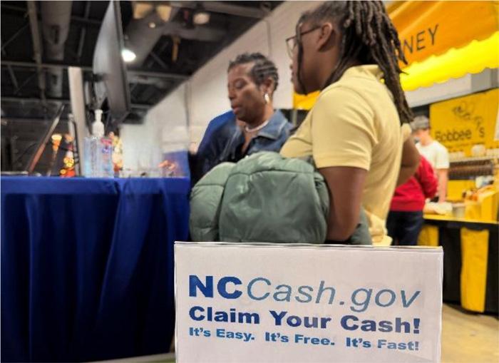 Fairgoers check to see if they have any unclaimed property.