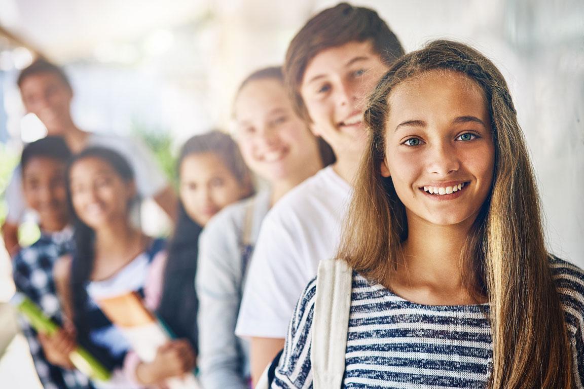 Young student (female) in front of a line of blurry students