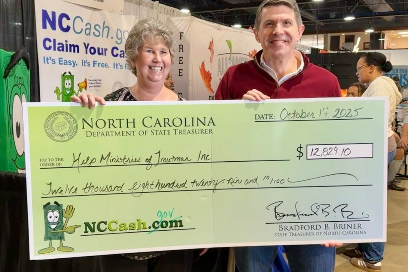 State Treasurer Brad Briner presents Donna Lambert, president of Help Ministries of Troutman, with a $12,829.10 check.