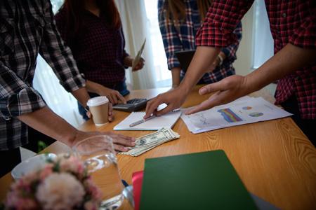 Team of students (implied) planning Investment strategy